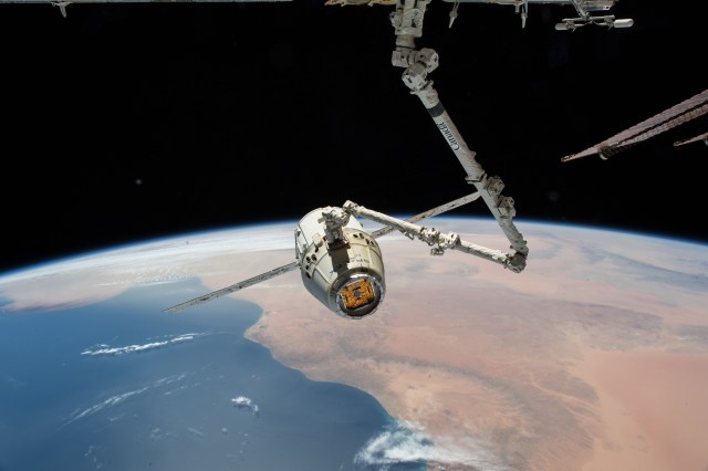 The SpaceX Dragon cargo craft is pictured in the grips of the Canadarm2 robotic arm as the International Space Station was orbiting above northern Africa. Dragon would be released a few hours later for its splashdown in the Pacific Ocean off the coast of California on May 5, 2018 ending the SpaceX CRS-14 mission.
