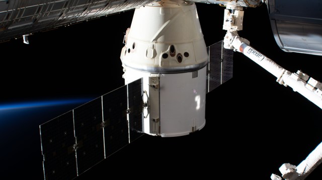iss062e087409 (March 9, 2020) --- The SpaceX Dragon resupply ship is pictured attached to the International Space Station's Harmony module as both spacecraft were soaring into an orbital sunrise 264 miles above the American state of Nevada.