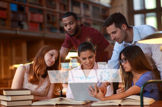 Five college students in a library look at a tablet as simulated screen shots float in the air.