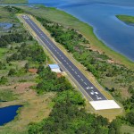 An east to west aerial photograph of the Unmanned Aerial System (UAS) Airstrip surrounded by vegetation and water, on the northern end of NASA Wallops Flight Facility's Wallops Island in Accomack County, Virginia.