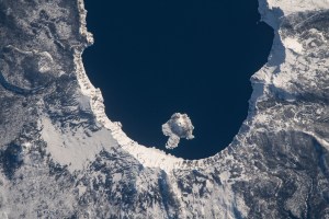 iss070e099660 (Feb. 23, 2024) -- A snow-covered Crater Lake National Park is visible from the International Space Station as it orbits 261 miles above Oregon. The park sees snow most of the year, which feeds into the lake, crowned the deepest in the United States. Near the west end of the lake is Wizard Island, a volcanic cinder cone.