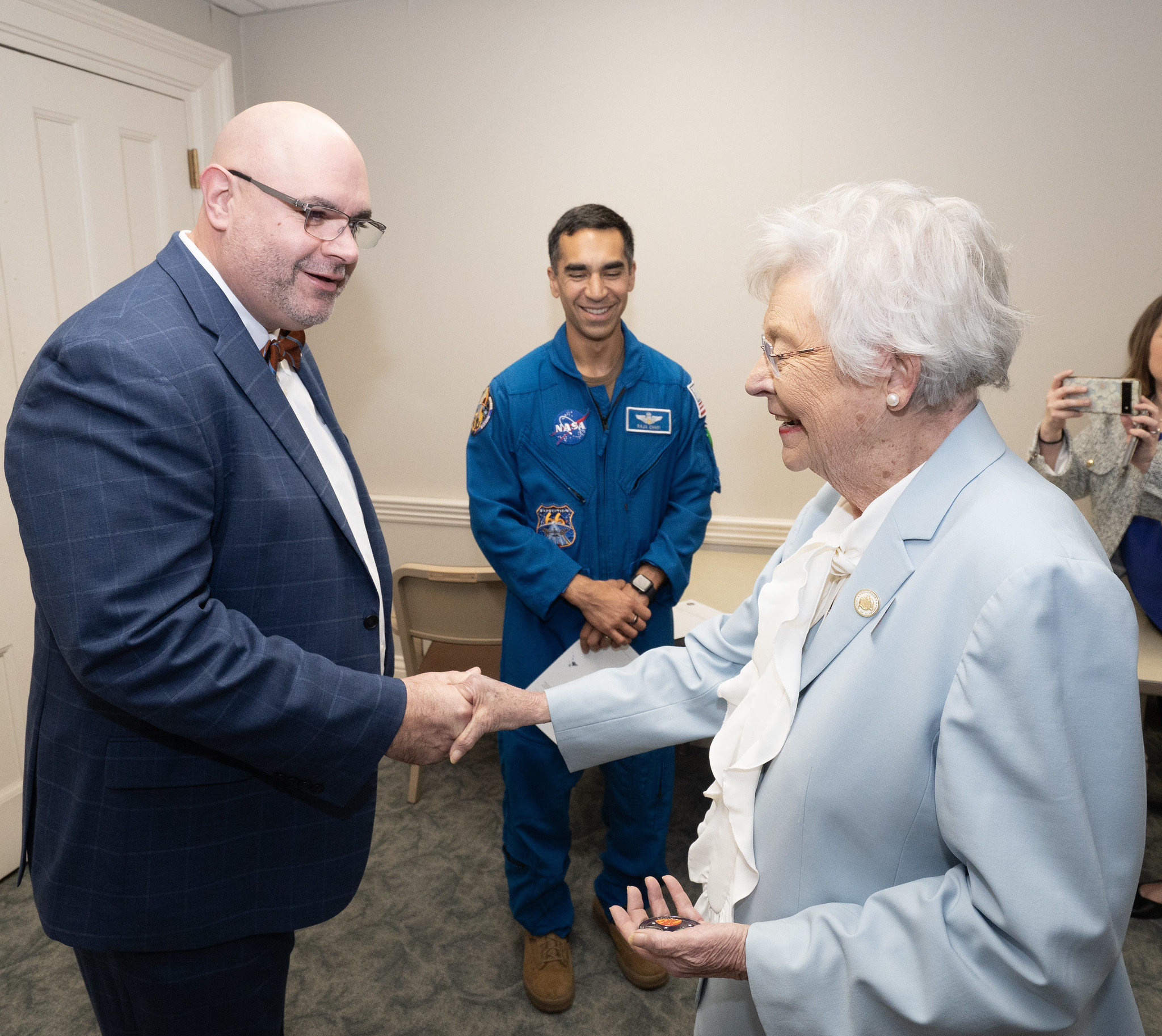 Alabama Gov. Kay Ivey, right, greets Pelfrey during Alabama Space Day as NASA astronaut Raja Chari, center, looks on. The governor issued a proclamation declaring the state holiday in honor of the aerospace industry's impact on Alabama.