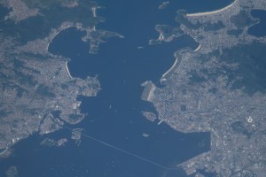 iss070e108427 (March 5, 2024) --- Rio De Janeiro, Brazil (at right), and its suburbs just across the Guanabara Bay are pictured from the International Space Station as it orbited 265 miles above the Atlantic Ocean. Toward the bottom, is the eight-and-a-quarter-mile long President Costa e Silva Bridge linking Rio de Janeiro with the city of Niterói.