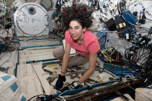 iss070e108256 (March 6, 2024) --- Expedition 70 Flight Engineer and NASA astronaut Jasmin Moghbeli prepares to open a science freezer for research operations inside the International Space Station's Kibo laboratory module.
