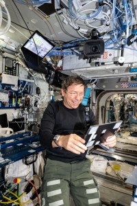 iss070e113283 (March 11, 2024) -- NASA astronaut and Expedition 70 Flight Engineer Michael Barratt uses an iPad to review the on-orbit schedule for residents aboard the International Space Station.
