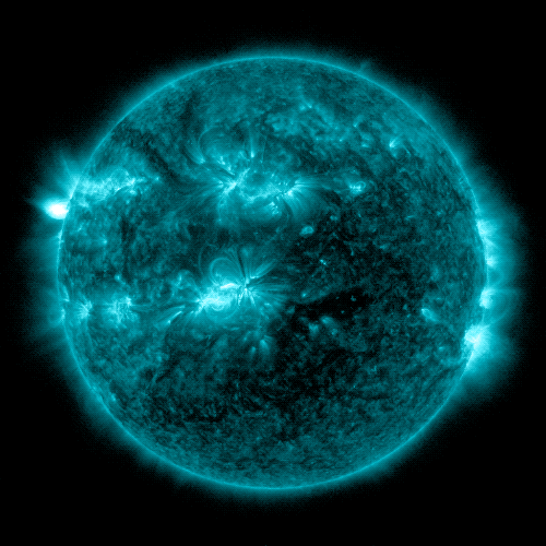 A view of the Sun colorized in blue shows two bright flashes of light near the Sun's center and top