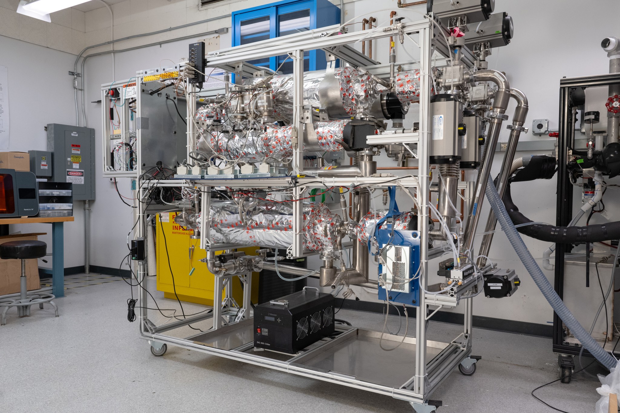 a large metal rack with lots of metal hardware and tubes, etcetera
