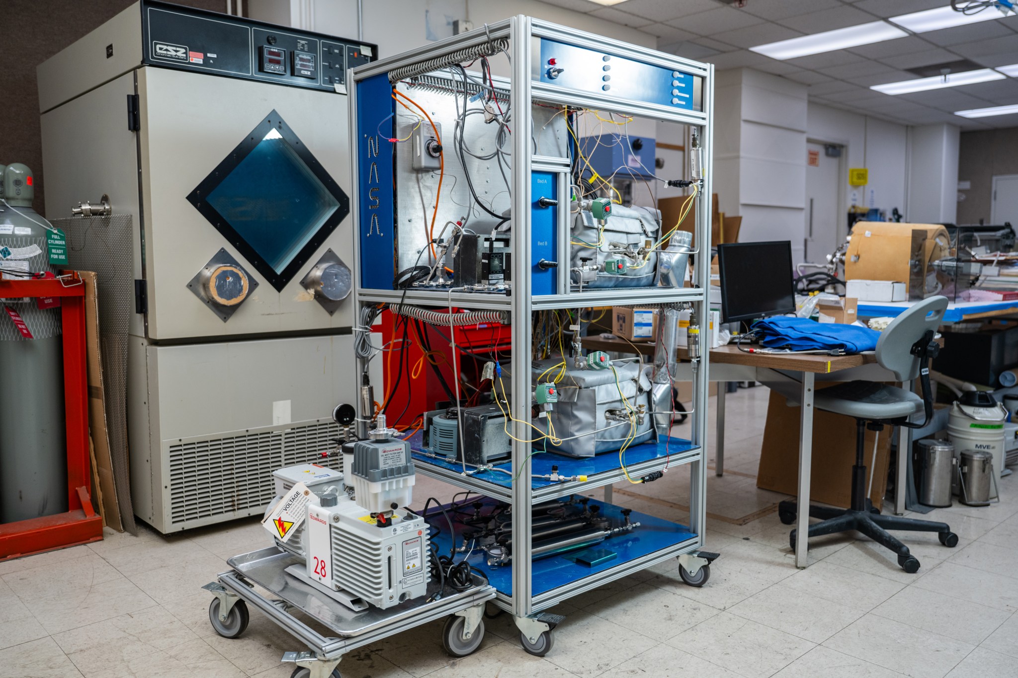 a rack in a laboratory with lots of machinery and tubes on it