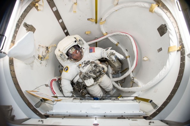 NASA astronaut and Expedition 53 Flight Engineer Mark Vande Hei verifies his U.S. spacesuit fits while inside the International Space Station's U.S. Quest airlock.