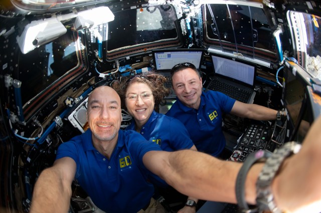 iss060e082572 (Sept. 28, 2019) --- Astronauts (from left) Luca Parmitano, Christina Koch and Andrew Morgan are pictured at the robotics workstation inside the cupola, the International Space Station's "window to the world." Japan's H-II Transfer Vehicle-8 (HTV-8) arrived the same day and Koch commanded the Canadarm2 robotic arm to reach out and grapple the HTV-8, beginning a month of cargo transfer activities.