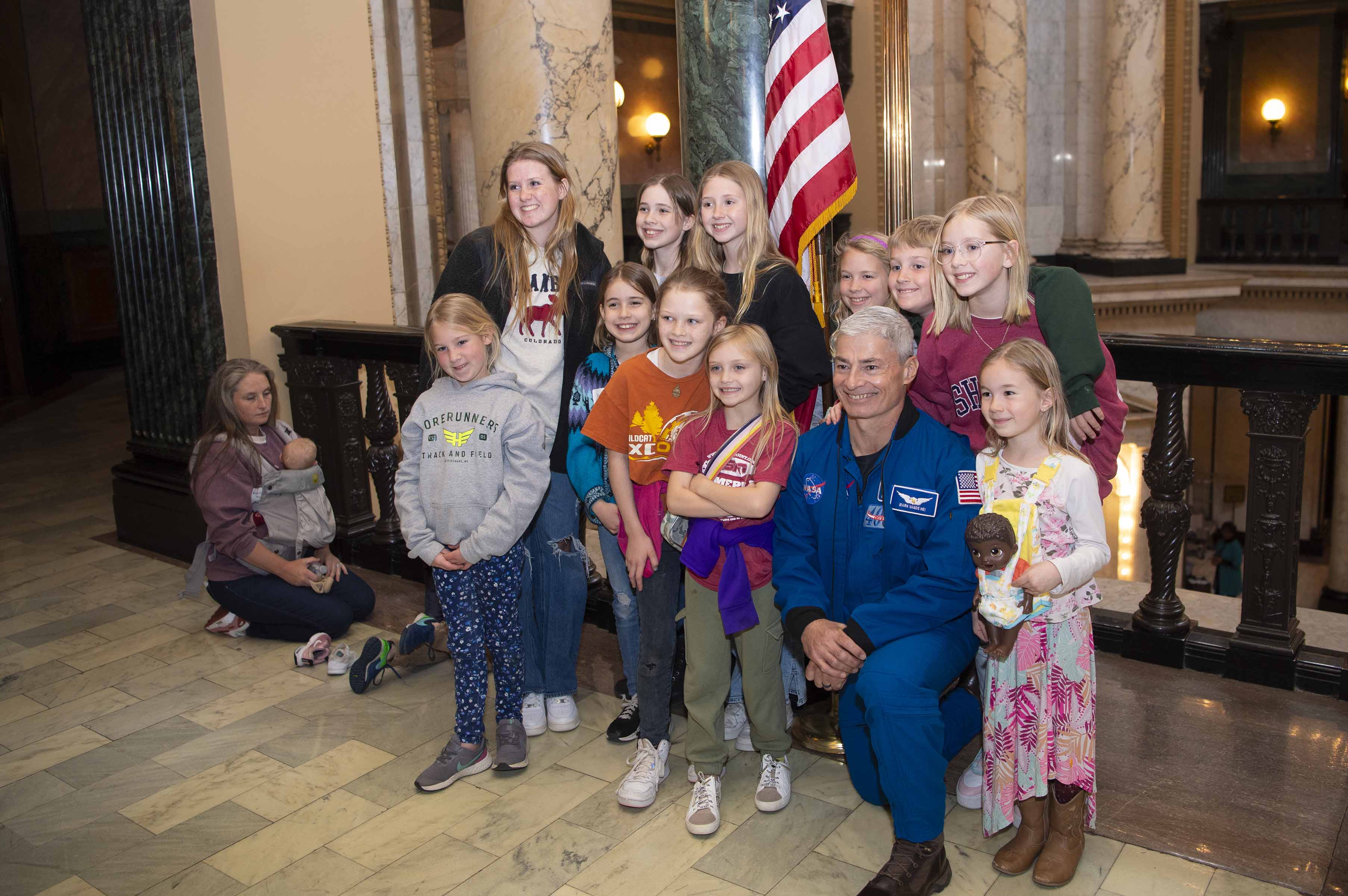 NASA astronaut Mark Vande Hei is pictured with children visiting the Mississippi State Capitol in Jackson, Mississippi