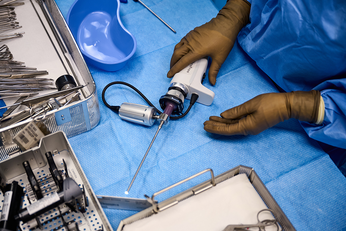 Lazurite's ArthroFree Wireless Camera System on a table, held by a person wearing surgical gloves.