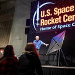NASA technologist Les Johnson, on stage, discusses how the solar sail can use solar propulsion to travel farther in space than anyone has traveled before during an exhibit held March 12 at the U.S. Space & Rocket Center.