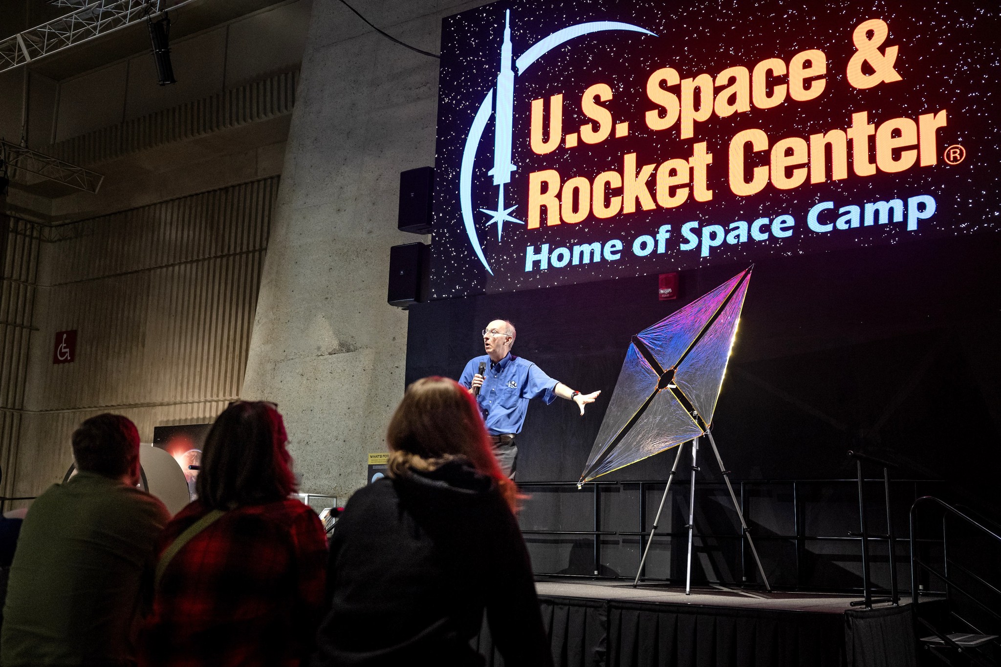 NASA technologist Les Johnson, on stage, discusses how the solar sail can use solar propulsion to travel farther in space than anyone has traveled before during an exhibit held March 12 at the U.S. Space & Rocket Center.