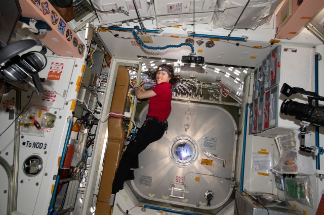 iss060e001460 (June 28, 2019) --- Expedition 60 Flight Engineer Christina Koch of NASA partially installs cables inside the Unity module to support Canadarm2 robotic arm operations aboard the International Space Station.
