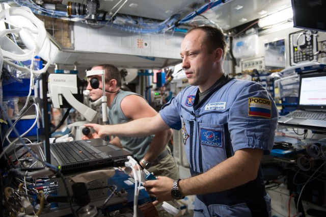 Cosmonauts Alexander Misurkin (foreground) and Sergey Ryazanskiy participate in a remotely guided eye exam with assistance from doctors on Earth using Optical Coherence Tomography gear. Misurkin was the Crew Medical Officer and Ryazanskiy was the subject helping doctors understand how living in microgravity impacts vision.