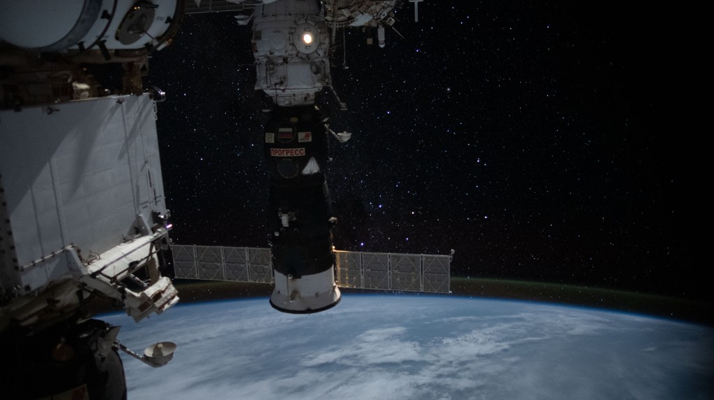 iss060e006636 (July 11, 2019) --- Earth's atmospheric glow is back-dropped by a starry Milky Way as the International Space Station orbited 258 miles above Myanmar during an orbital nighttime pass. The Progress 72 resupply ship and the Pirs docking compartment with its lit airlock window silhouette the background.