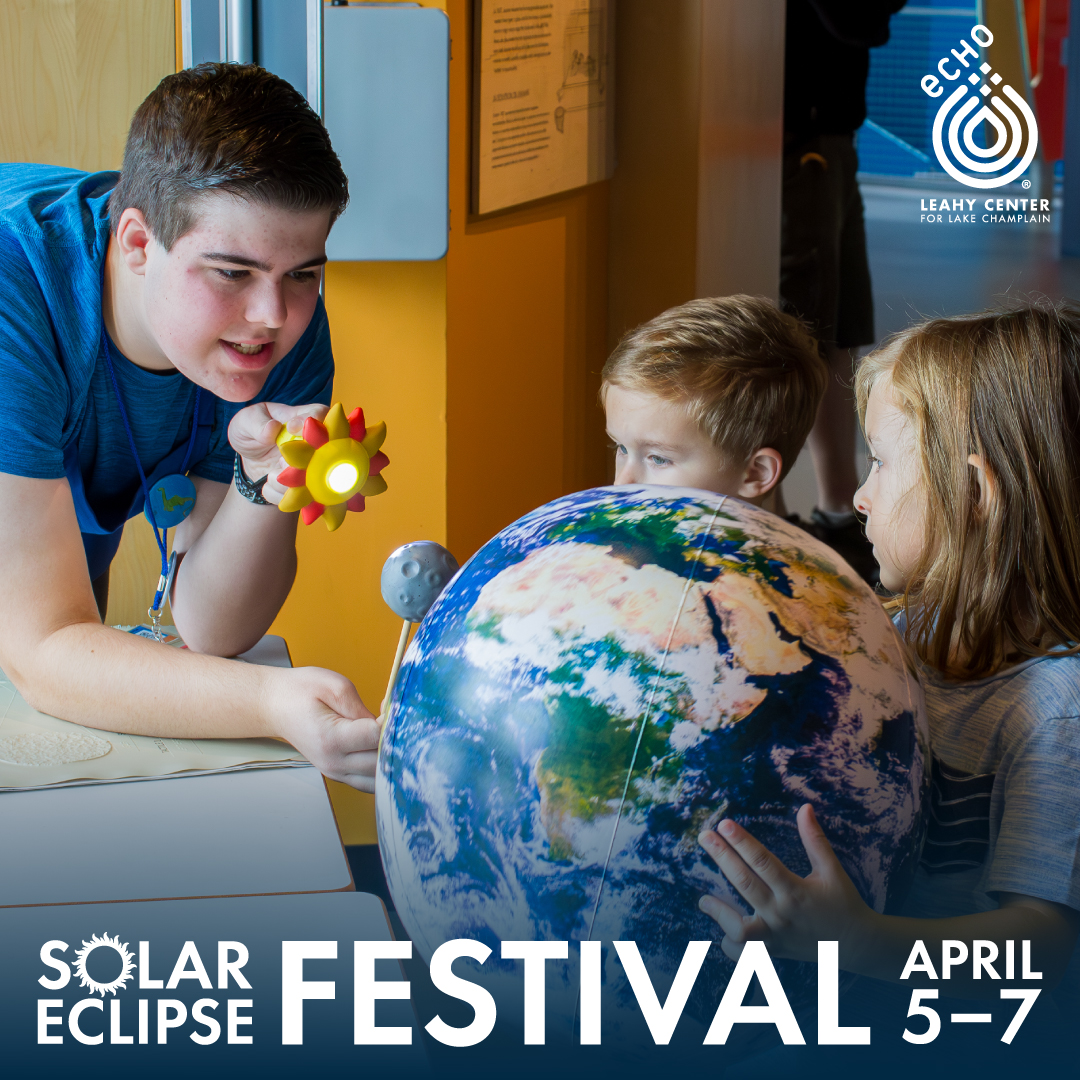 Solar eclipse Festival with teacher and students holding a 3d globe showing the solar eclipse.