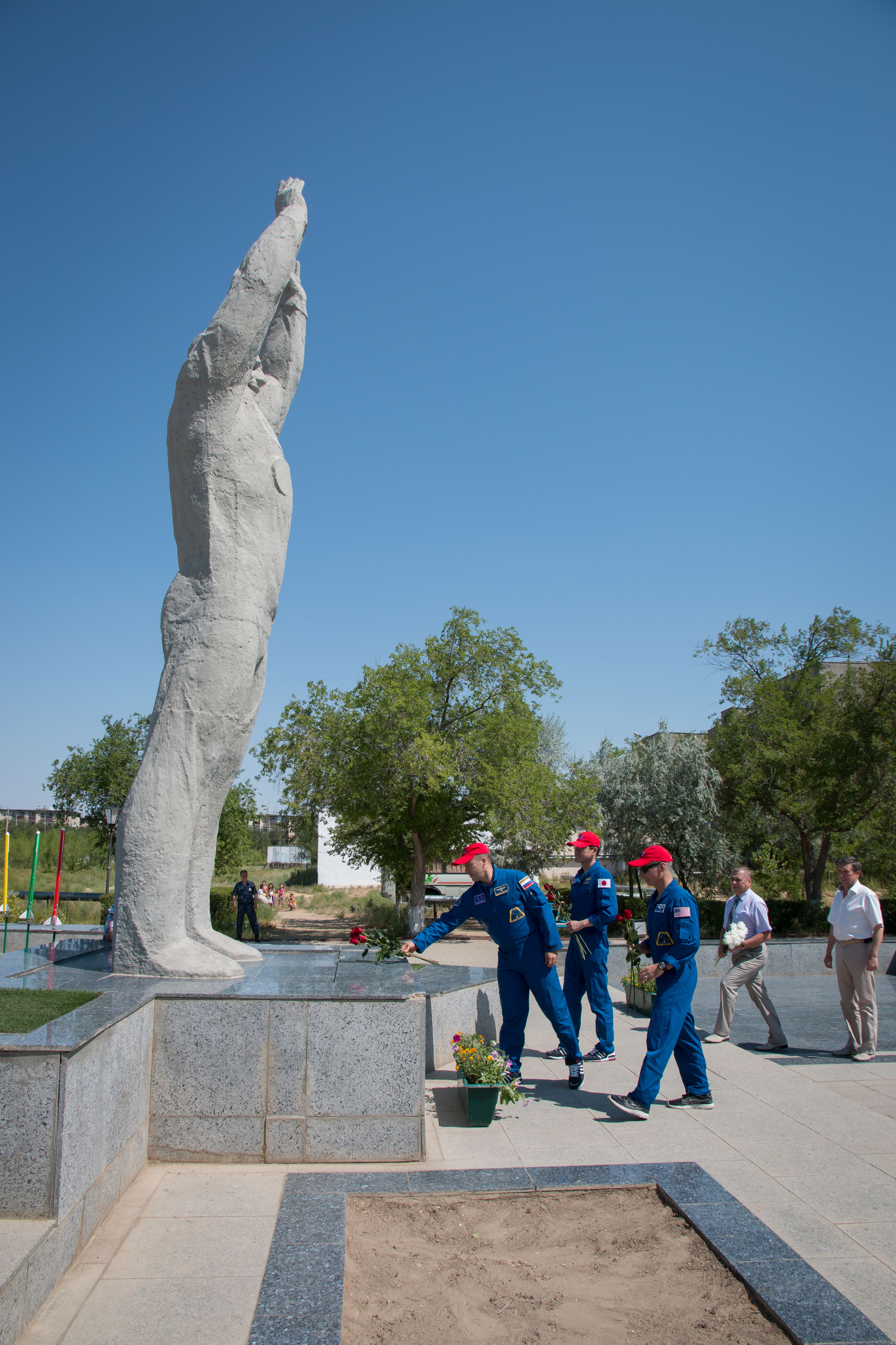 Expedition 52-53 backup crewmembers Alexander Misurkin of the Russian Federal Space Agency (Roscosmos, left), Norishige Kanai of the Japan Aerospace Exploration Agency (JAXA, center) and Mark Vande Hei of NASA (right) lay flowers at the statue of Yuri Gagarin, the first human in space, in the town of Baikonur, Kazakhstan July 18 during traditional pre-launch ceremonies. They are serving as backups to Randy Bresnik of NASA, Sergey Ryazanskiy of Roscosmos and Paolo Nespoli of the European Space Agency, who will launch July 28 on the Soyuz MS-05 spacecraft from the Baikonur Cosmodrome for a five-month mission on the International Space Station.