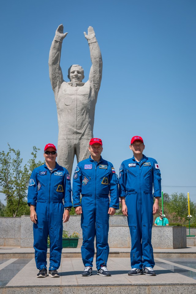 Expedition 52-53 backup crewmembers Mark Vande Hei of NASA (left), Alexander Misurkin of the Russian Federal Space Agency (Roscosmos, center) and Norishige Kanai of the Japan Aerospace Exploration Agency (JAXA, right) pose for pictures in front of the statue of Yuri Gagarin, the first human in space, in the town of Baikonur, Kazakhstan July 18 during traditional pre-launch ceremonies. They are serving as backups to Randy Bresnik of NASA, Sergey Ryazanskiy of Roscosmos and Paolo Nespoli of the European Space Agency, who will launch July 28 on the Soyuz MS-05 spacecraft from the Baikonur Cosmodrome for a five-month mission on the International Space Station.