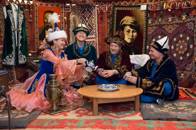 In the town of Baikonur, Kazakhstan, Expedition 52-53 backup crewmembers Norishige Kanai of the Japan Aerospace Exploration Agency (JAXA, second from left), Alexander Misurkin of the Russian Federal Space Agency (Roscosmos, second from right) and Mark Vande Hei of NASA (far right) enjoy a traditional cup of tea in a mockup of a Russian “yurt” or tent in Baikonur’s space museum July 18 as part of traditional pre-launch ceremonies. They are serving as backups to Sergey Ryazanskiy of Roscosmos, Randy Bresnik of NASA and Paolo Nespoli of the European Space Agency, who will launch July 28 on the Soyuz MS-05 spacecraft from the Baikonur Cosmodrome for a five-month mission on the International Space Station.