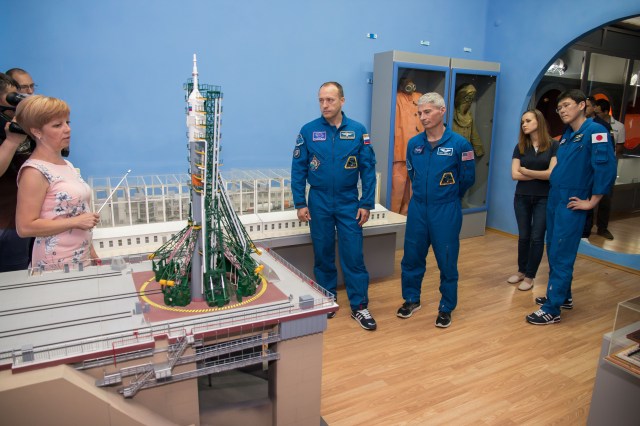 Expedition 52-53 backup crewmembers Alexander Misurkin of the Russian Federal Space Agency (Roscosmos, left), Mark Vande Hei of NASA (center) and Norishige Kanai of the Japan Aerospace Exploration Agency (JAXA, right) receive a briefing on a model of Soyuz rocket in the space museum in the town of Baikonur, Kazakhstan July 18. The three are serving as backups to Sergey Ryazanskiy of Roscosmos, Randy Bresnik of NASA and Paolo Nespoli of the European Space Agency, who will launch July 28 on the Soyuz MS-05 spacecraft from the Baikonur Cosmodrome for a five-month mission on the International Space Station.