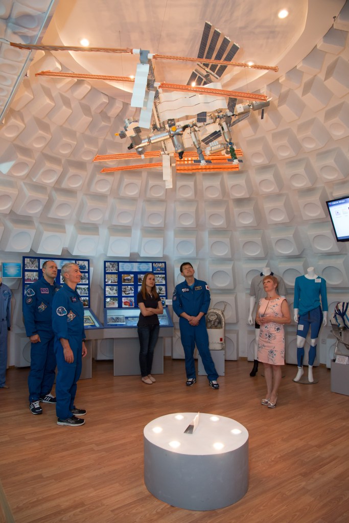 Expedition 52-53 backup crewmembers Alexander Misurkin of the Russian Federal Space Agency (Roscosmos, left), Mark Vande Hei of NASA (second from left) and Norishige Kanai of the Japan Aerospace Exploration Agency (JAXA, second from right) receive a briefing on some of the artifacts in the space museum in the town of Baikonur, Kazakhstan July 18. The three are serving as backups to Sergey Ryazanskiy of Roscosmos, Randy Bresnik of NASA and Paolo Nespoli of the European Space Agency, who will launch July 28 on the Soyuz MS-05 spacecraft from the Baikonur Cosmodrome for a five-month mission on the International Space Station.