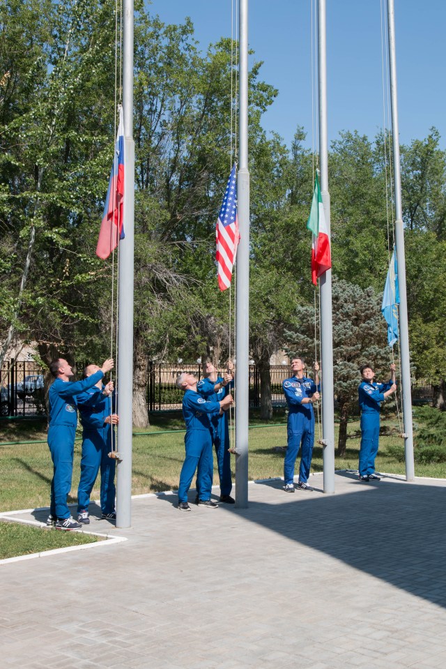 At the Cosmonaut Hotel crew quarters in Baikonur, Kazakhstan, the Expedition 52-53 prime and backup crewmembers raised the flags of the U.S., Russia, Italy and Kazakhstan July 18 during traditional pre-launch ceremonies. From left to right are Sergey Ryazanskiy and Alexander Misurkin of the Russian Federal Space Agency (Roscosmos) raising the Russian flag, Mark Vande Hei and Randy Bresnik of NASA raising the U.S. flag, Paolo Nespoli of the European Space Agency raising the flag of Italy and Norishige Kanai of the Japan Aerospace Exploration Agency (JAXA) raising the flag of Kazakhstan. Ryazanskiy, Bresnik and Nespoli will launch July 28 on the Soyuz MS-05 spacecraft from the Baikonur Cosmodrome for a five-month mission on the International Space Station.