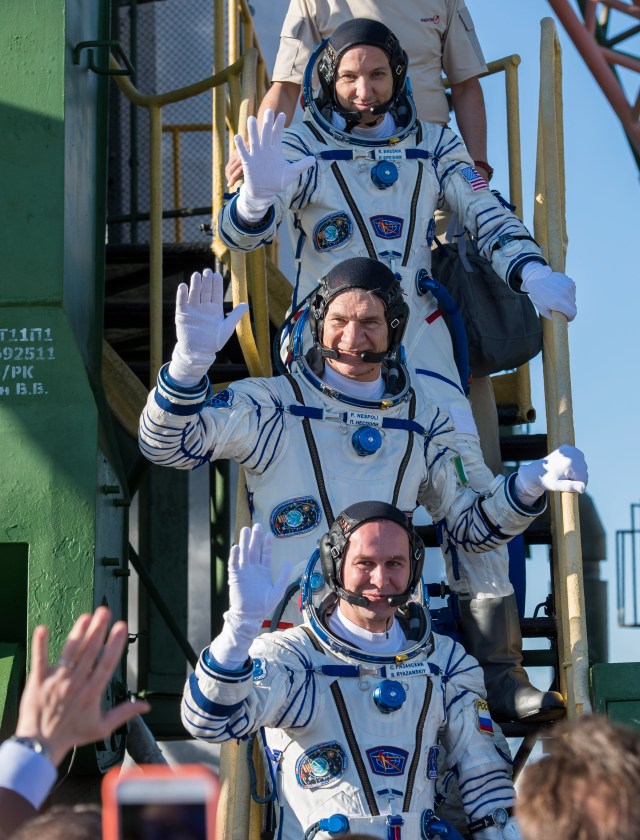 Expedition 52 flight engineer Randy Bresnik of NASA, top, flight engineer Paolo Nespoli of ESA (European Space Agency), middle, and flight engineer Sergei Ryazanskiy of Roscosmos, bottom, wave farewell prior to boarding the Soyuz MS-05 rocket for launch, Friday, July 28, 2017 at the Baikonur Cosmodrome in Kazakhstan. Ryazanskiy, Bresnik, and Nespoli will spend the next four and a half months living and working aboard the International Space Station.