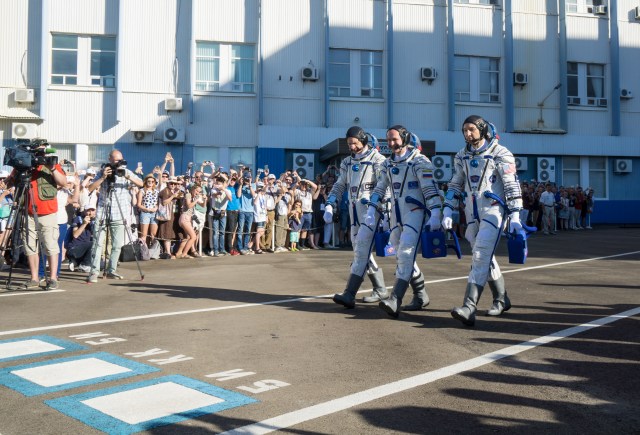 Expedition 52 flight engineer Paolo Nespoli of ESA (European Space Agency), left, flight engineer Sergei Ryazanskiy of Roscosmos, center, and flight engineer Randy Bresnik of NASA, right, walk out Building 254 as they prepare to depart for the launch pad, Friday, July 28, 2017 in Baikonur, Kazakhstan. The Soyuz rocket launched at 11:41 a.m. EDT on July 28 (9:41 p.m. Baikonur time) to start Ryazanskiy, Bresnik, and Nespoli on a four and a half month mission aboard the International Space Station.
