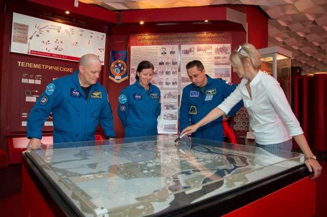 At the Space Museum in the town of Baikonur, Kazakhstan, Expedition 53-54 backup crewmembers Scott Tingle of NASA (left), Shannon Walker of NASA (center) and Anton Shkaplerov of Roscosmos (right) receive a briefing on the layout of the Baikonur Cosmodrome from a museum guide in a traditional pre-launch activity Sept. 8. They are serving as backups to the prime crewmembers, Joe Acaba of NASA, Alexander Misurkin of Roscosmos and Mark Vande Hei of NASA, who will launch on Sept. 13 from the Baikonur Cosmodrome in Kazakhstan on the Soyuz MS-06 spacecraft for a five and a half month mission on the International Space Station.