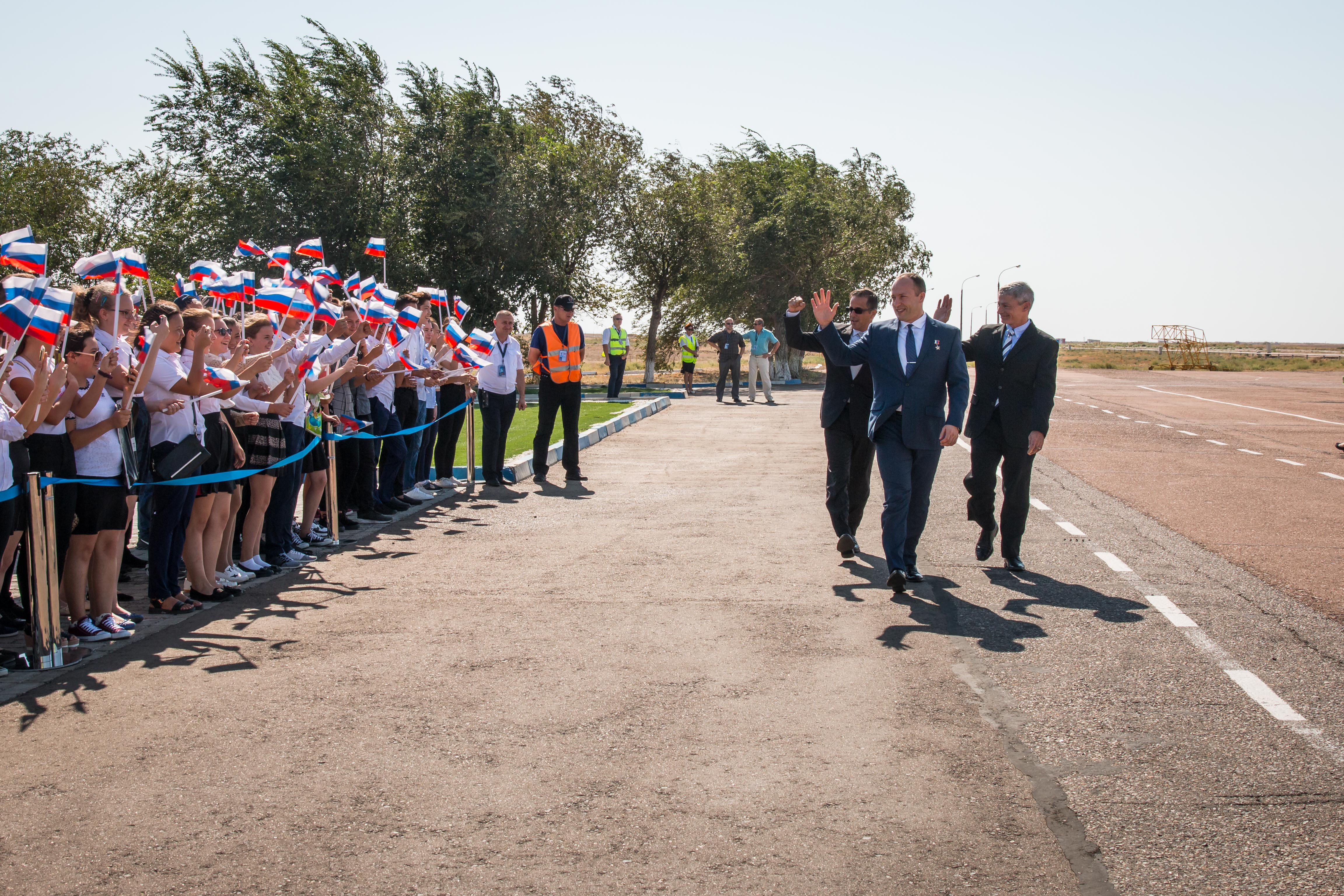 Expedition 53-54 crewmembers Joe Acaba of NASA (left), Alexander Misurkin of Roscosmos (center) and Mark Vande Hei of NASA (right) are greeted by local students after arriving at their launch site at the Baikonur Cosmodrome in Kazakhstan Sept. 6 following a flight from their training base in Star City, Russia for final pre-launch training. They will launch Sept. 13 on the Soyuz MS-06 spacecraft from the Baikonur Cosmodrome for a five and a half month mission on the International Space Station.