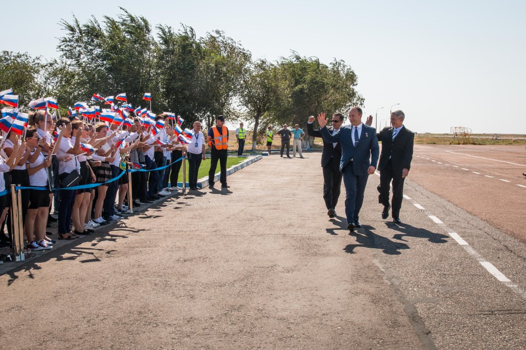 Expedition 53-54 crewmembers Joe Acaba of NASA (left), Alexander Misurkin of Roscosmos (center) and Mark Vande Hei of NASA (right) are greeted by local students after arriving at their launch site at the Baikonur Cosmodrome in Kazakhstan Sept. 6 following a flight from their training base in Star City, Russia for final pre-launch training. They will launch Sept. 13 on the Soyuz MS-06 spacecraft from the Baikonur Cosmodrome for a five and a half month mission on the International Space Station.