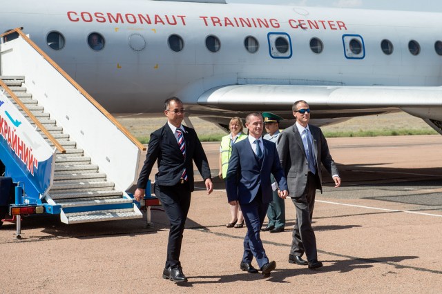 jsc2019e038366 (July 4, 2019) --- At the Baikonur Cosmodrome in Kazakhstan, Expedition 60 backup crewmembers Soichi Noguchi of the Japan Aerospace Exploration Agency (left), Sergey Ryzhikov of Roscosmos (center) and Tom Marshburn of NASA (left) arrive July 4 after a flight from their training base outside Moscow for final pre-launch preparations. They are the backups to Drew Morgan of NASA, Alexander Skvortsov of Roscosmos and Luca Parmitano of the European Space Agency, who will launch July 20 from the Baikonur Cosmodrome in Kazakhstan on the Soyuz MS-13 spacecraft for a mission on the International Space Station. Credit: Andrey Shelepin/GCTC