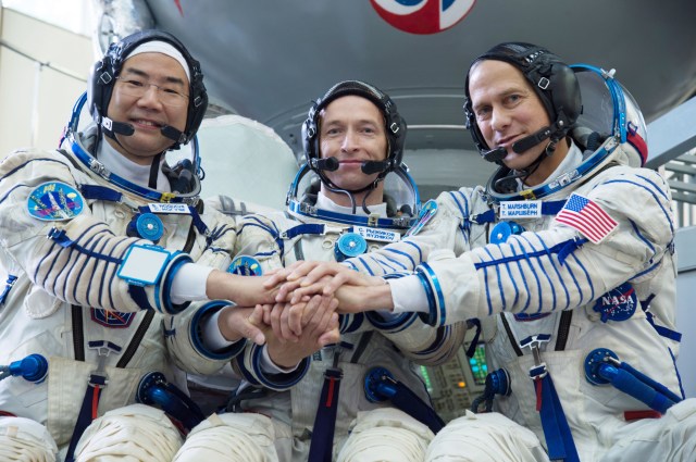 jsc2019e035256 (June 26, 2019) --- At the Gagarin Cosmonaut Training Center in Star City, Russia, Expedition 60 backup crewmembers Soichi Noguchi of the Japan Aerospace Exploration Agency (left), Sergey Ryzhikov of Roscosmos (center) and Tom Marshburn of NASA (right) pose for pictures June 26 during their final qualification exams. They are the backups to the prime crew, Alexander Skvortsov of Roscosmos, Drew Morgan of NASA and Luca Parmitano of the European Space Agency, who will launch July 20 on the Soyuz MS-13 spacecraft from the Baikonur Cosmodrome in Kazakhstan for a mission on the International Space Station. Credit: NASA/Beth Weissinger