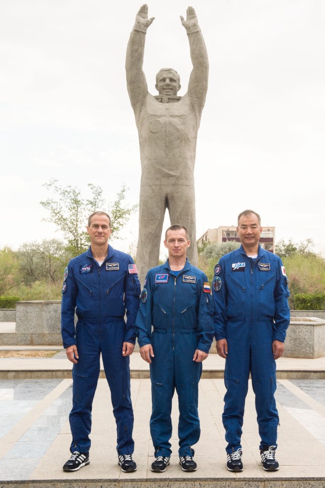 jsc2019e038393 (July 6, 2019) --- In the town of Baikonur, Kazakhstan, Expedition 60 backup crewmembers Tom Marshburn of NASA (left), Sergey Ryzhikov of Roscosmos (center) and Soichi Noguchi of the Japan Aerospace Exploration Agency (right) pose for pictures July 6 in front of the statue of Yuri Gagarin, the first human to fly in space, during traditional pre-launch activities. They are the backups to Drew Morgan of NASA, Luca Parmitano of the European Space Agency and Alexander Skvortsov of Roscosmos, who will launch July 20 on the Soyuz MS-13 spacecraft from the Baikonur Cosmodrome in Kazakhstan for a mission on the International Space Station. Credit: Andrey Shelepin/GCTC