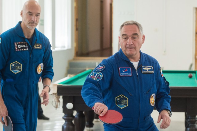 jsc2019e039258 (July 12, 2019) --- At the Cosmonaut Hotel crew quarters in Baikonur, Kazakhstan, Expedition 60 crewmember Alexander Skvortsov of Roscosmos (right) tries his hand at a game of ping-pong July 12 as crewmate Luca Parmitano of the European Space Agency (left) looks on. Skvortsov, Parmitano and Drew Morgan of NASA will launch July 20 on the Soyuz MS-13 spacecraft from the Baikonur Cosmodrome in Kazakhstan on a mission to the International Space Station. Credit: Andrey Shelepin/GCTC