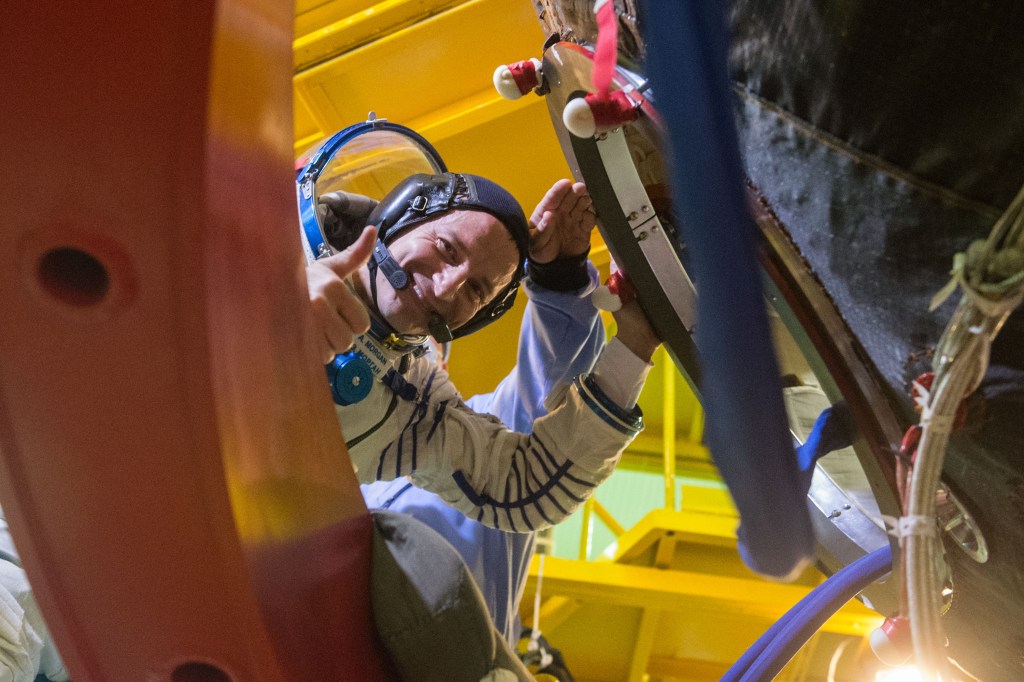jsc2019e038386 (July 5, 2019) --- At the Baikonur Cosmodrome in Kazakhstan, Expedition 60 crewmember Drew Morgan of NASA waves as he boards his Soyuz spacecraft July 5 for pre-launch preparations. Morgan, Luca Parmitano of the European Space Agency and Alexander Skvortsov of Roscosmos will launch July 20 on the Soyuz MS-13 spacecraft from the Baikonur Cosmodrome for a mission on the International Space Station. Credit: Andrey Shelepin/GCTC