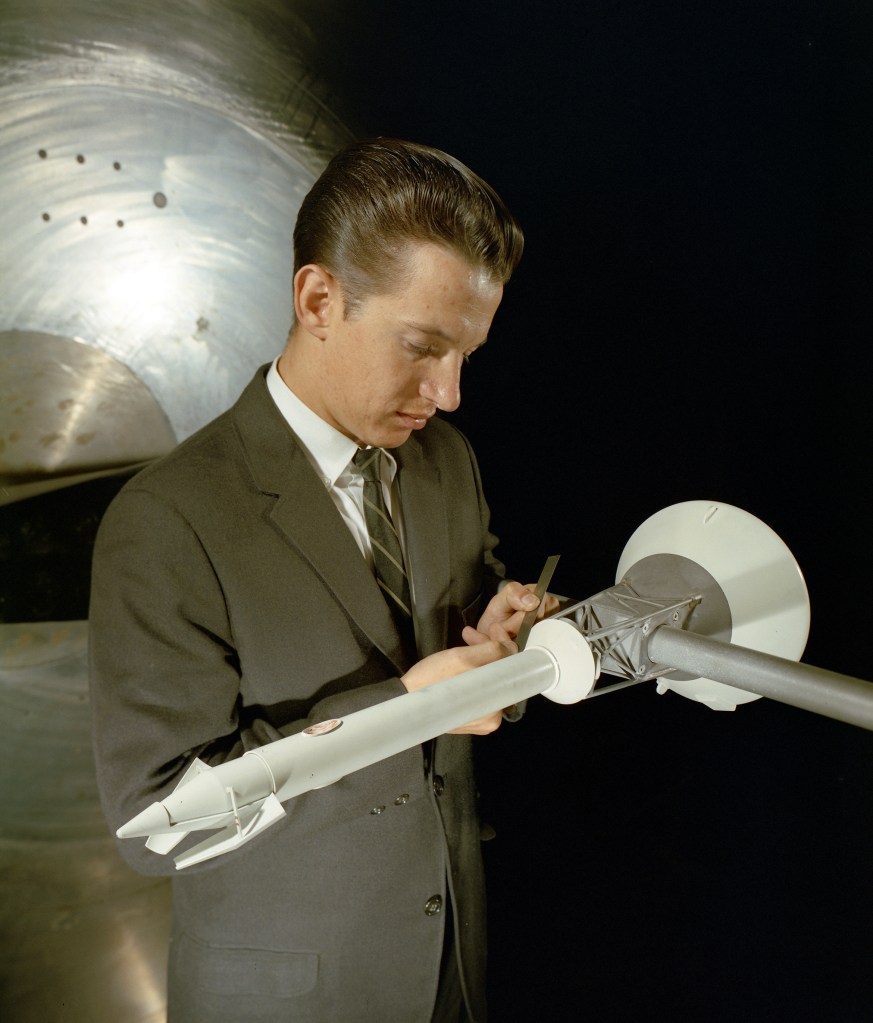 Man looking at model in tunnel.