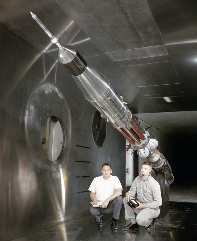 Two men with rocket model.