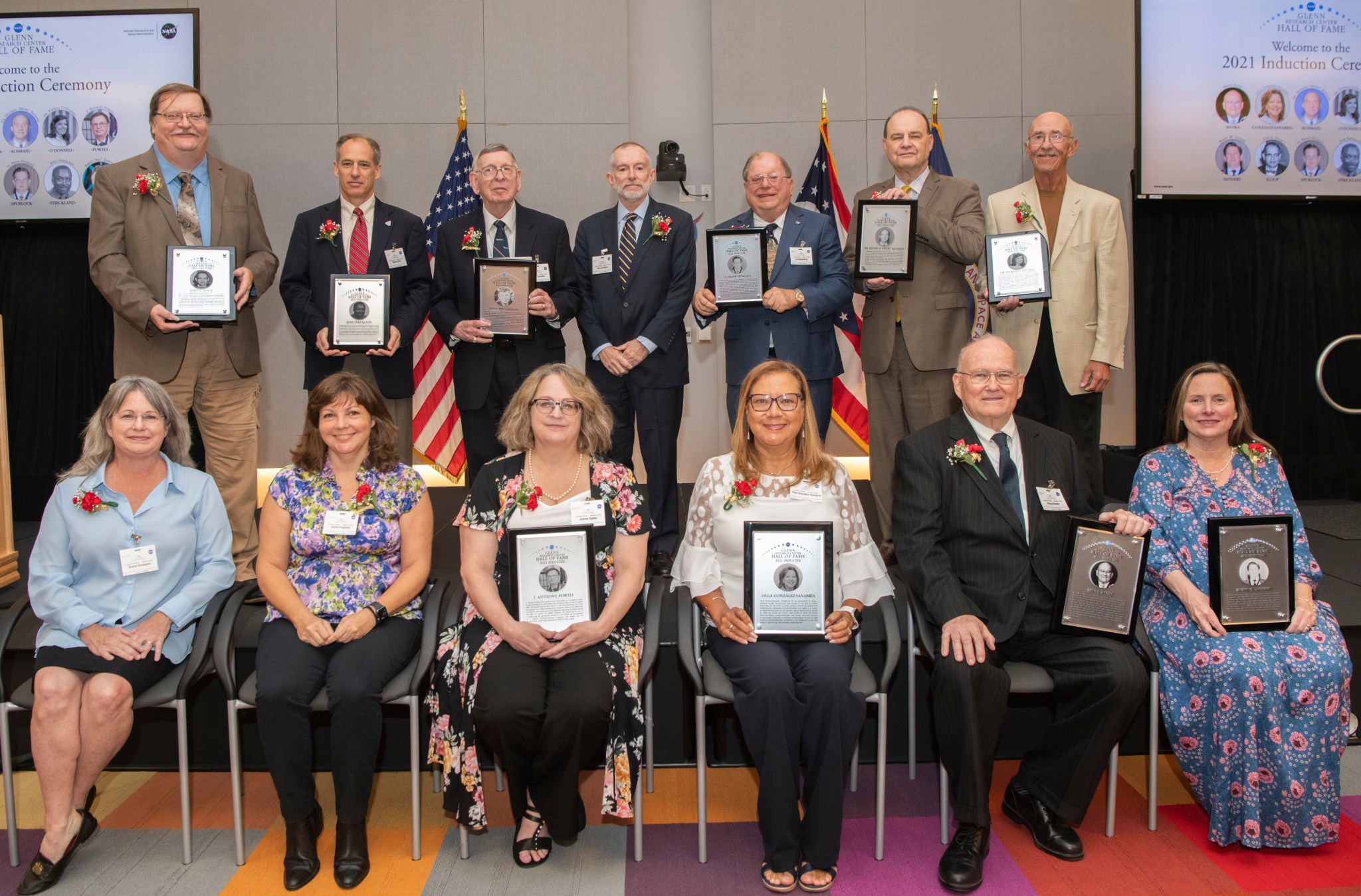 Group of people with plaques posing for photograph.