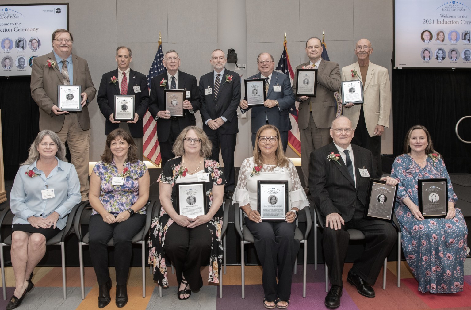 Group of people posing for photograph with plaques.