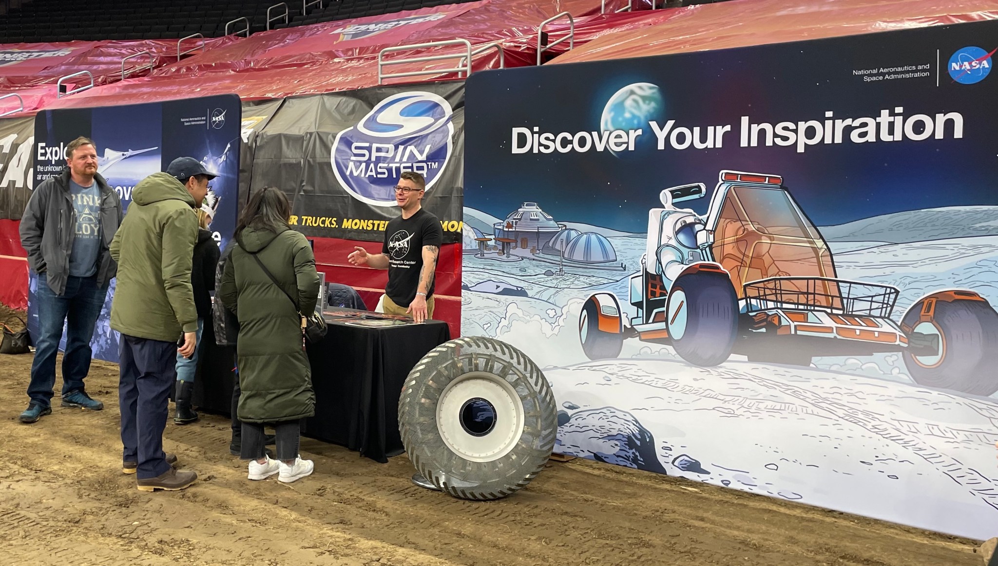 NASA Glenn Research Center’s Matthew Baeslack discusses NASA Glenn’s research on lunar tires with visitors at a Monster Jam in Milwaukee.