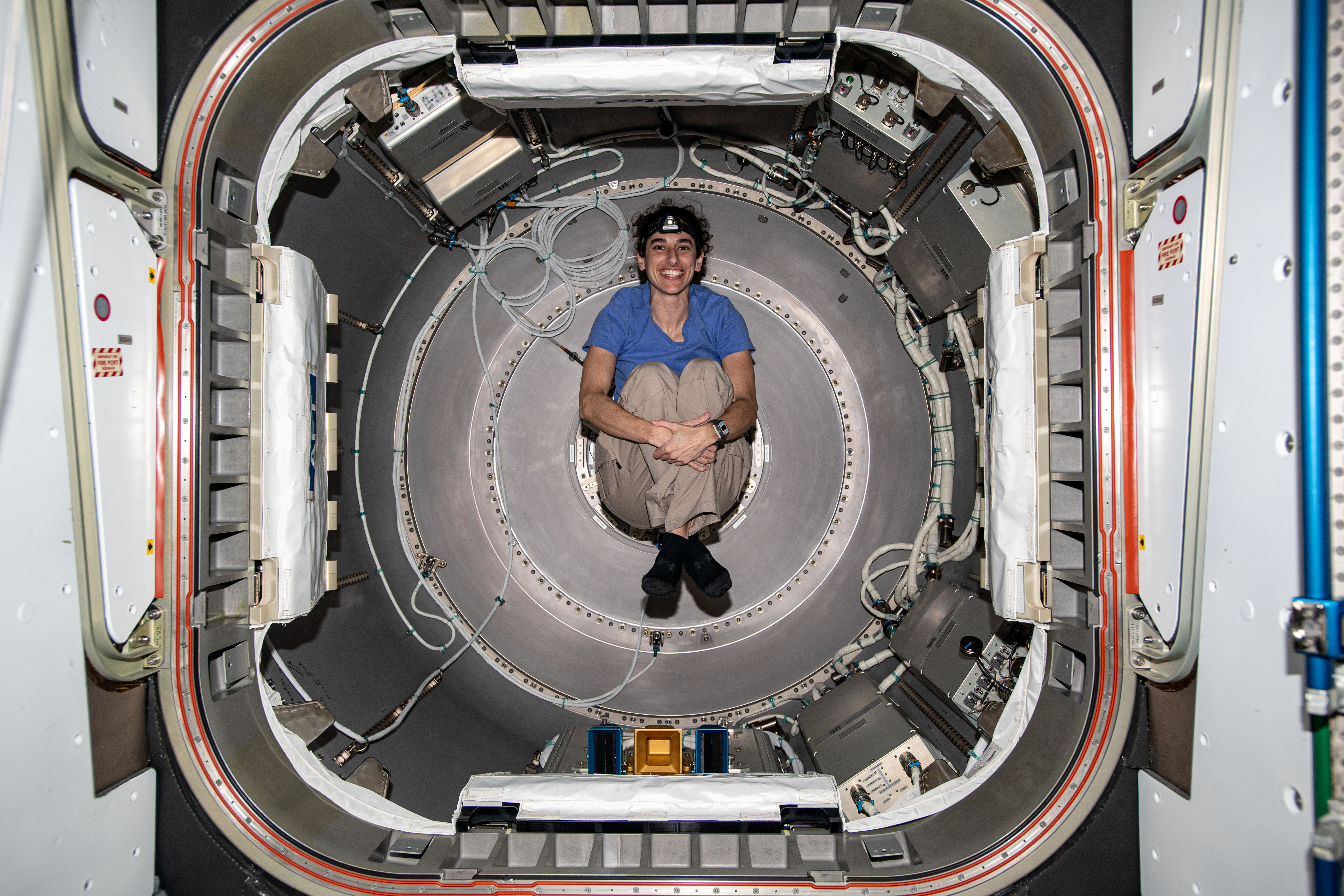 Expedition 70 Flight Engineer and NASA astronaut Jasmin Moghbeli is photographed inside the NanoRacks Bishop airlock. Bishop can be uninstalled from its home on the Tranquility module for portable operations. It can also be used to stow cargo and extract or install payloads.