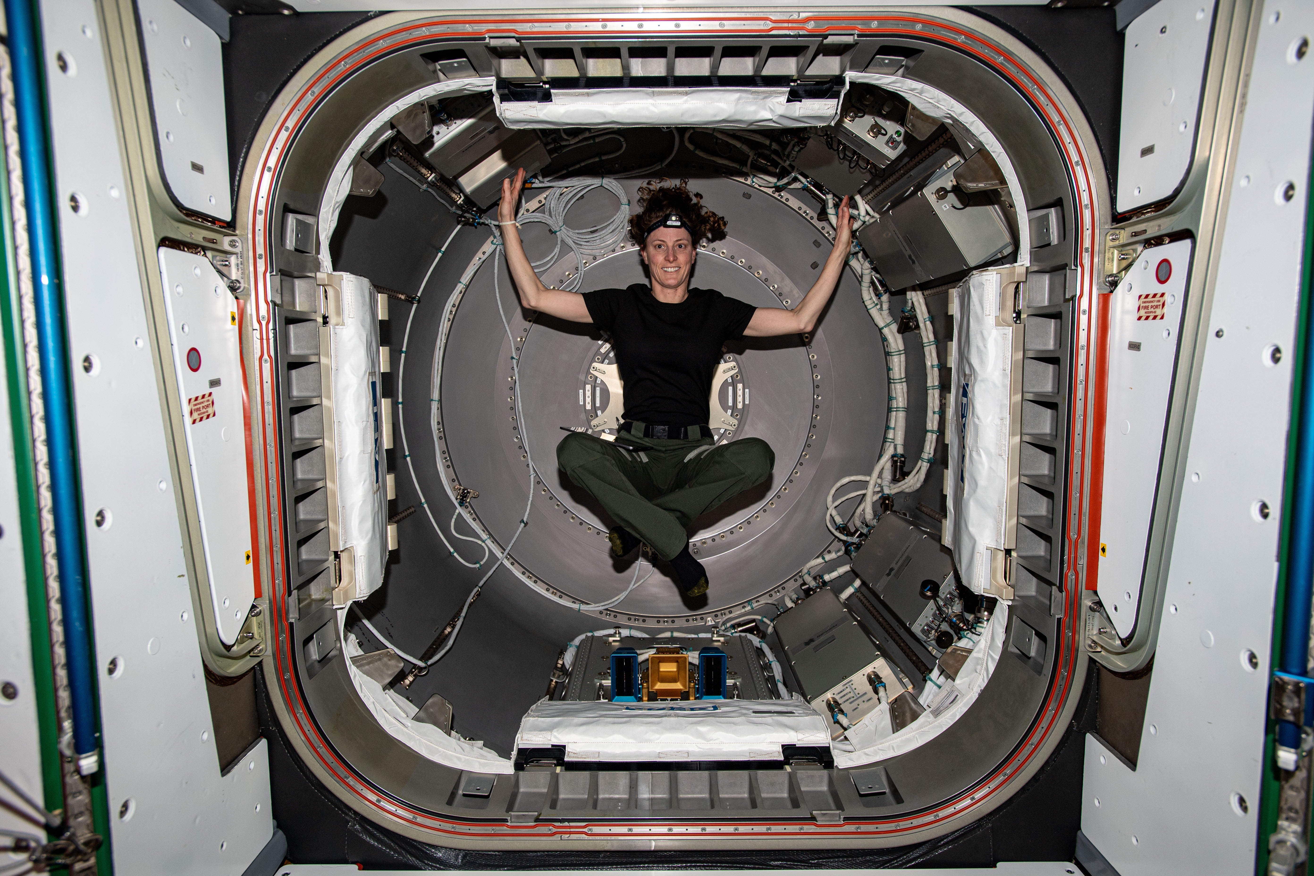 Expedition 70 Flight Engineer and NASA astronaut Loral O'Hara is photographed inside the NanoRacks Bishop airlock. Bishop can be uninstalled from its home on the Tranquility module for portable operations. It can also be used to stow cargo and extract or install payloads.
