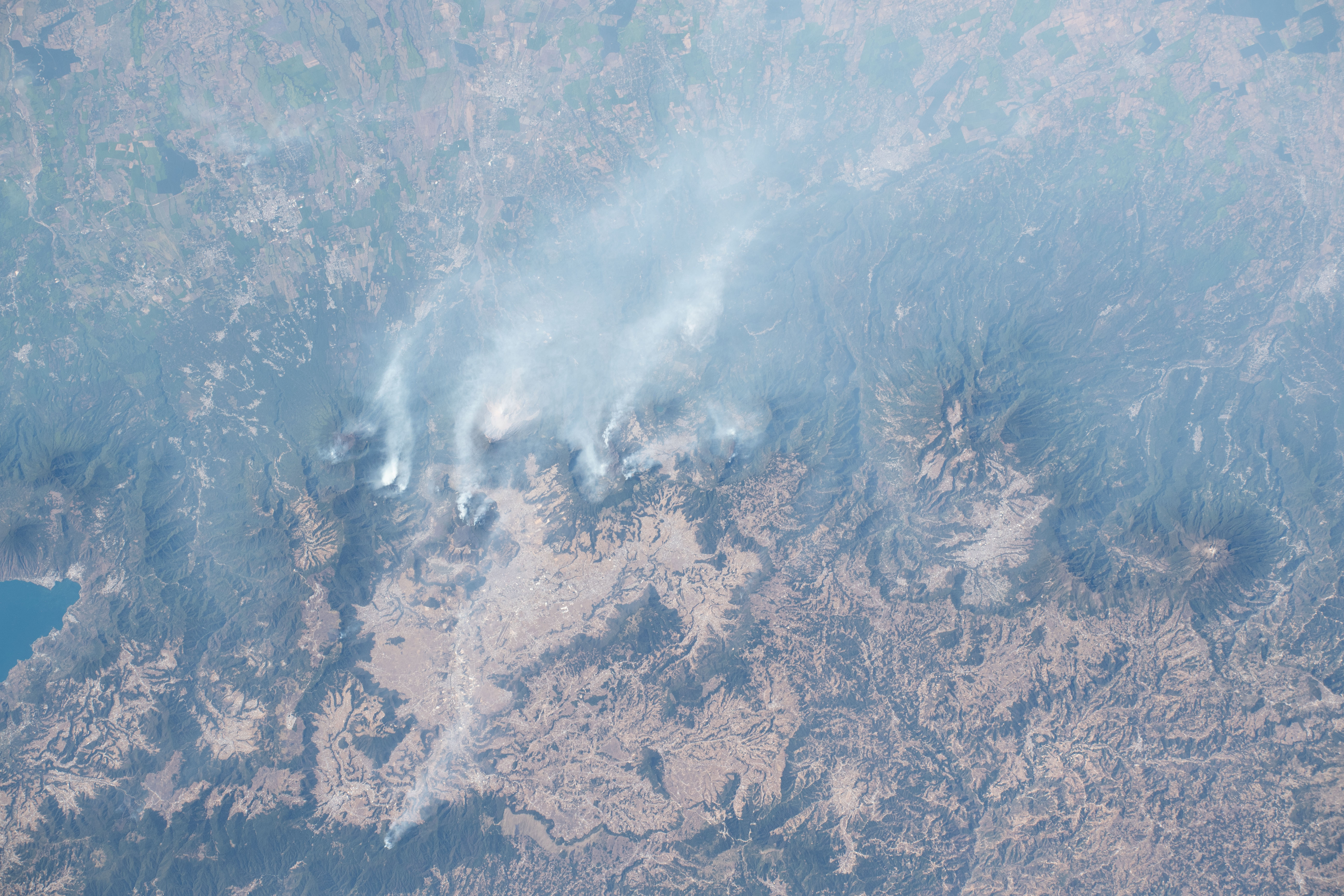 Wildfires fueled by hot, dry, and windy weather are pictured near the city of Quetzaltenango, Guatemala, by Expedition 70 Flight Engineer Jasmin Moghbeli of NASA as the International Space Station orbited 262 miles above the Central American nation.