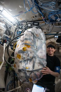 Expedition 70 Flight Engineer and NASA astronaut Loral O'Hara maneuvers obsolete hardware that she had packed for return to Earth. She removed from the components from inside the the Quest airlock's Common Cabin Air Assembly, a life support device that circulates, cools, and dehumidifies the International Space Station’s air.