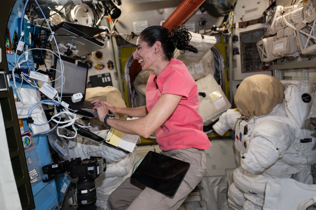 Expedition 70 Flight Engineer and NASA astronaut Jasmin Moghbeli works inside the Quest airlock where spacesuits are stored inside the International Space Station.