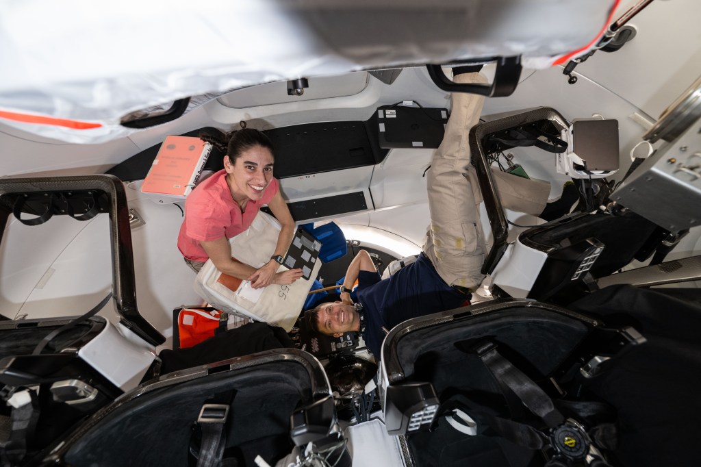 Expedition 70 Flight Engineers Jasmin Moghbeli and Matthew Dominick, both NASA astronauts, work inside a SpaceX Dragon crew spaceraft transferring emergency equipment from the International Space Station into the commercial crew vehicle.