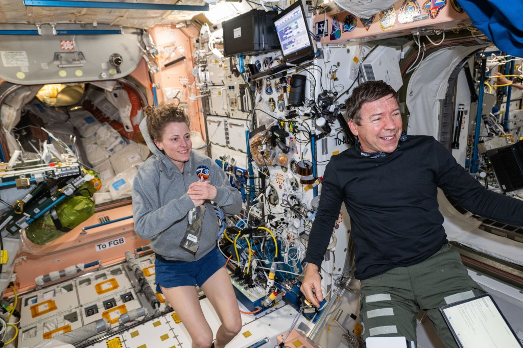 Expedition 70 Flight Engineers Loral O'Hara and Mike Barratt, both NASA astronauts, are pictured at work inside the International Space Station's Unity module.